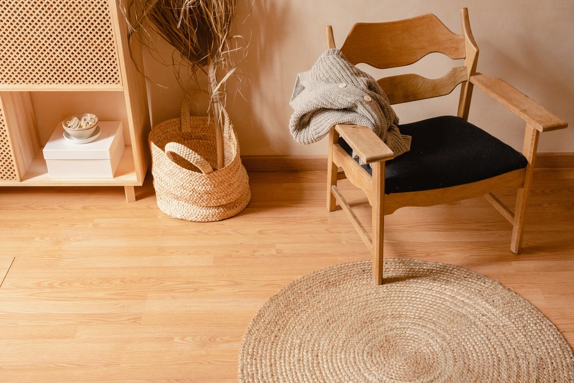 Wooden Armchair and Rattan Rug in Living Room